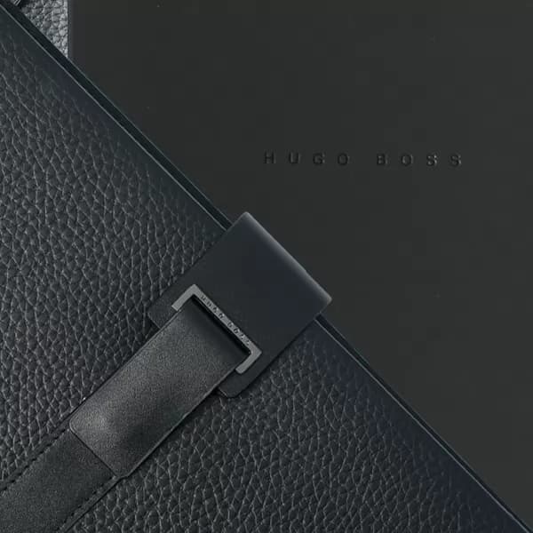 Pasta A4 preta em couro texturizado com detalhe de fecho e caixa com logo Hugo Boss